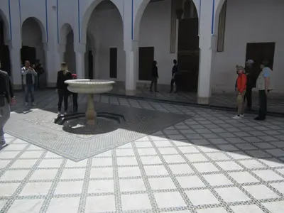a group of people standing in a building with a fountain at Riad AZARO in Marrakech