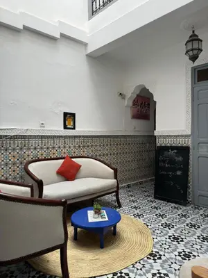 a living room with a couch and a table at RIAD DAR LFONOUN in Marrakech