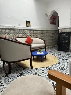 a living room with a couch and a table at RIAD DAR LFONOUN in Marrakech