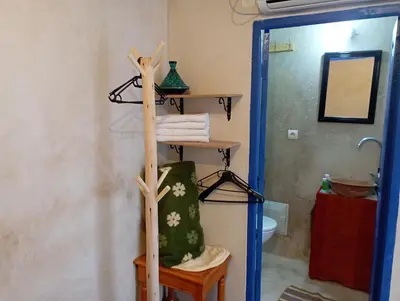 a bathroom with a towel rack and a toilet at RIAD DAR LFONOUN in Marrakech