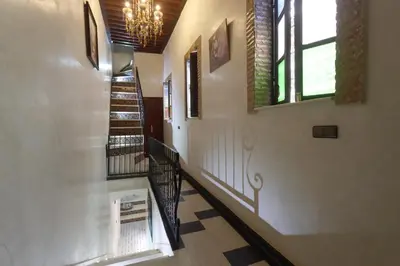 a hallway with stairs and a chandelier at Riad Dwiriyat My Teib in Marrakech