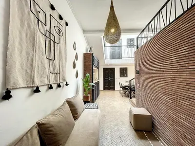 a living room with a couch and a wooden wall at Riad Le Twenty 6 in Marrakech