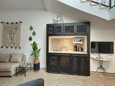 a living room with a couch and a tv at Riad Le Twenty 6 in Marrakech
