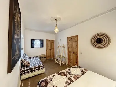 a room with two beds and a camera in it at Riad Le Twenty 6 in Marrakech