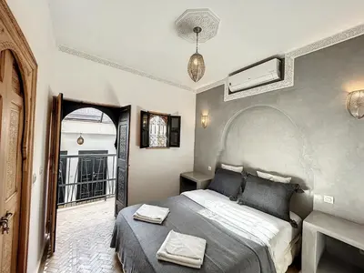 a bedroom with a bed in a room with a window at Riad Le Twenty 6 in Marrakech