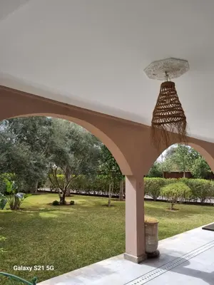 an archway with an umbrella on top of a yard at Riad les deux citronniers in Marrakech