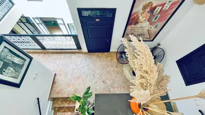 a hallway with a staircase with a blue door at Riad Kadi in Marrakech