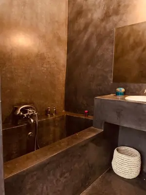 a bathroom with a bath tub and a sink at Riad Kadi in Marrakech
