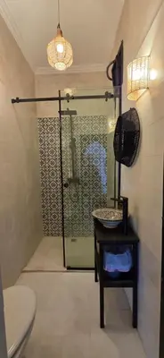 a bathroom with a shower with a sink and a toilet at Riad Kadi in Marrakech
