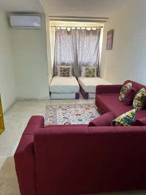 a living room with two purple couches and a window at Appartement 33 in Marrakech
