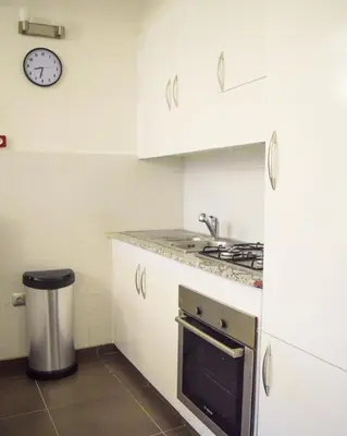a kitchen with white cabinets and a stove top oven at Apartment in Marrakesh, Gueliz in Marrakech