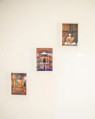 a group of framed paintings on a white wall at Apartment in Marrakesh, Gueliz in Marrakech