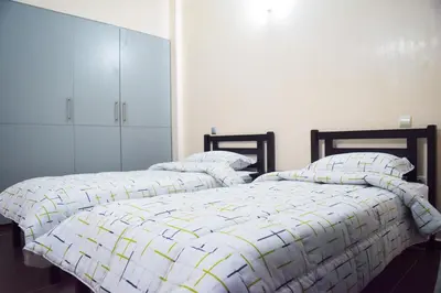 two beds sitting next to each other in a bedroom at Apartment in Marrakesh, Gueliz in Marrakech
