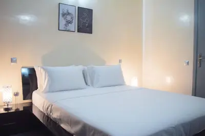 a bedroom with a white bed with white pillows at Apartment in Marrakesh, Gueliz in Marrakech