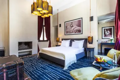 a hotel room with a bed and a fireplace at Riad Tajania in Marrakech