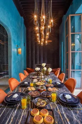 a long table with plates of food on it at Riad Tajania in Marrakech