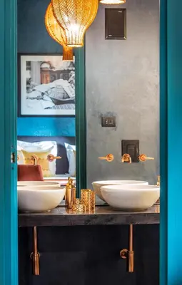 a bathroom with three white sinks on a counter at Riad Tajania in Marrakech