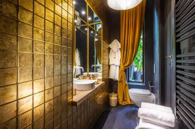a bathroom with a toilet and a sink and a mirror at Riad Tajania in Marrakech