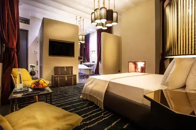 a hotel room with a bed and a living room at Riad Tajania in Marrakech