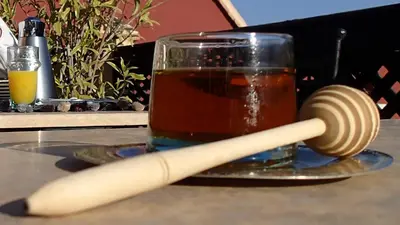 a cup of tea and a baseball bat next to a glass at Riad Jenaï L'Authentique in Marrakech