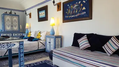 a living room with a couch and a bed at Riad Jenaï L'Authentique in Marrakech