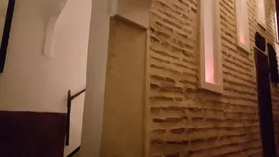 a room with a brick wall and a window at Riad Jenaï L'Authentique in Marrakech