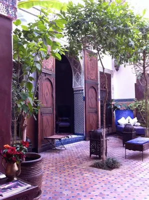 an entrance to a courtyard with a large wooden door at Riad Jenaï L'Authentique in Marrakech