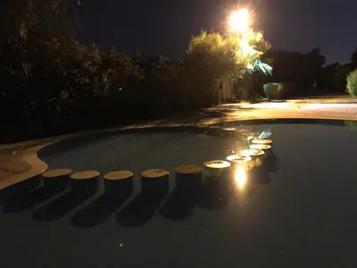 a swimming pool at night with lights on it at Annakil Appart in Marrakech
