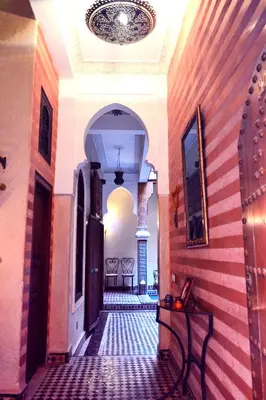 an empty hallway in a building with a ceiling at Riad Charik in Marrakech