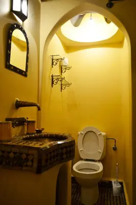 a bathroom with a toilet and a sink at Riad Charik in Marrakech