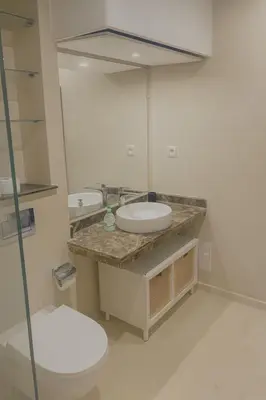 a bathroom with a sink and a toilet and a mirror at Apt standing 80m2, 2 chambres, terrasse, piscine in Marrakech