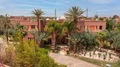 an aerial view of a house with palm trees at Mimouna Riads in Marrakech