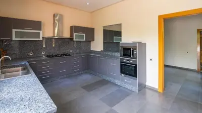 a kitchen with a sink and a stove top oven at Mimouna Riads in Marrakech