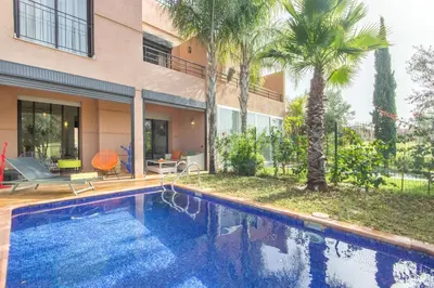 a swimming pool in front of a house at Villa Cosy - Jardin de l'Atlas - Golf & Waky in Marrakech