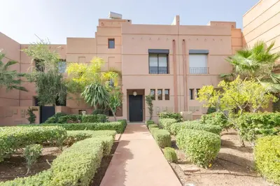 a building with trees in front of it at Villa Cosy - Jardin de l'Atlas - Golf & Waky in Marrakech