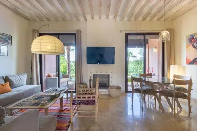 a living room with a couch and a table at Villa Cosy - Jardin de l'Atlas - Golf & Waky in Marrakech