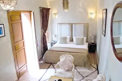 a bedroom with a large bed and a mirror at Riad Zamzam & Spa in Marrakech