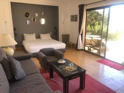 a living room with a bed and a couch and a table at Oasis Jena Marrakech in Marrakech