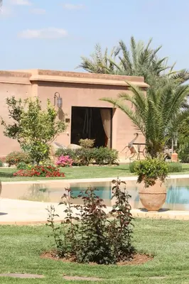 a house with a swimming pool in a yard at Oasis Jena Marrakech in Marrakech
