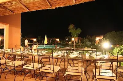 a long table with chairs and food on it at Oasis Jena Marrakech in Marrakech