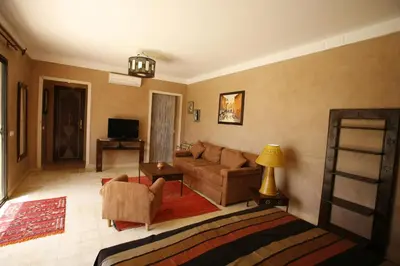 a living room with a couch and a table at Oasis Jena Marrakech in Marrakech