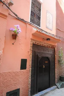 a building with a door with a flower pot on it at Riad Basma Marrakech in Marrakech