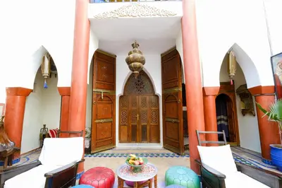 an entrance to a building with a wooden door at Riad Basma Marrakech in Marrakech