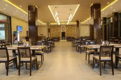a dining room with tables and chairs in a restaurant at LE VOYAGEUR MARRAKECH in Marrakech