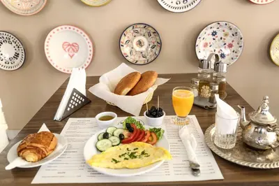 a table with a breakfast plate of eggs and bread at LE VOYAGEUR MARRAKECH in Marrakech