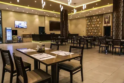 a dining room with tables and chairs in a restaurant at LE VOYAGEUR MARRAKECH in Marrakech