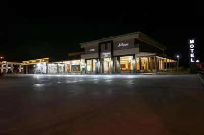 an empty parking lot in front of a store at night at LE VOYAGEUR MARRAKECH in Marrakech
