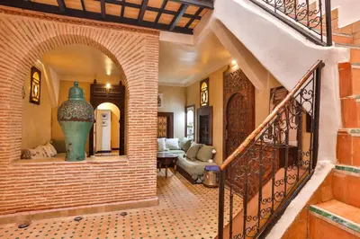 a hallway of a house with a staircase and a vase at Riad Dada Mouss & Suites in Marrakech
