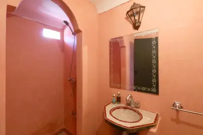 a bathroom with a sink and a mirror at Riad Capri in Marrakech