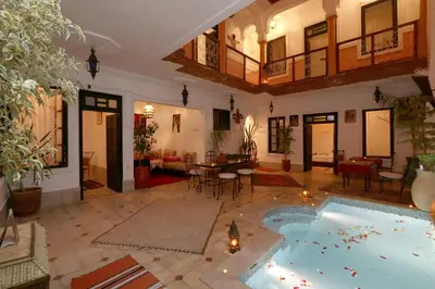 a large living room with a large pool in the middle of it at Riad Capri in Marrakech